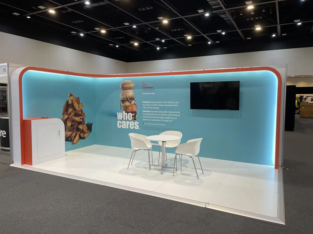 Exhibition stand with teal curved wall and product imagery
